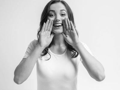 a woman with both hands around her mouth 